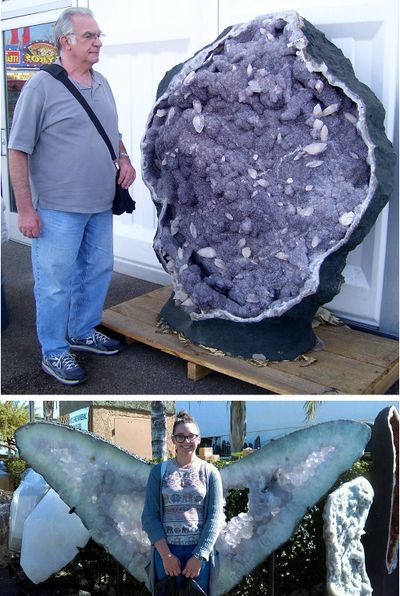 My dad and my daughter standing next to  large amethyst pieces in Tucson, Arizona