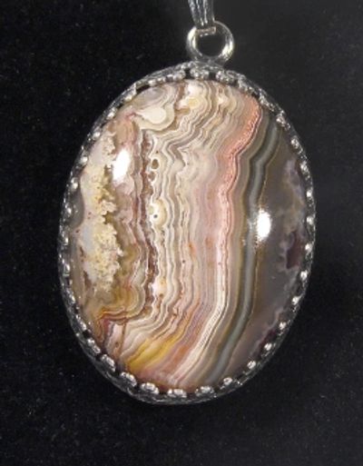 Crazy Lace Agate pendant with a hand cut and polished cabochon by Beverly Jenkins