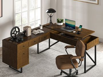 Modern L-shaped wooden office desk with a brown swivel chair and decor.