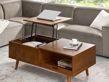 Wooden coffee table with lift-top and storage in a modern living room.