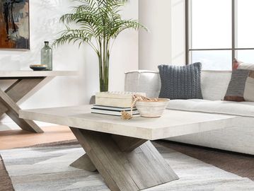 Modern living room with a geometric wooden coffee table and cozy sofa.