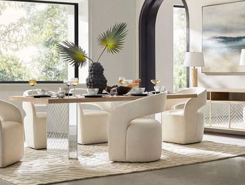 Modern dining room with beige chairs, wooden table, and large window.