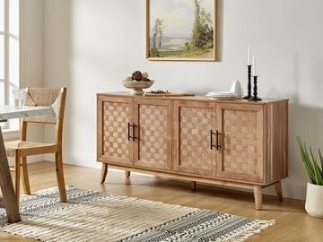 Wooden sideboard with woven door panels in a cozy dining room setup.