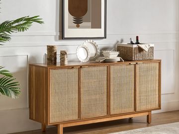 Wooden sideboard with woven cabinet doors in a minimalist room.