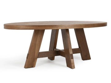 Round wooden table with sturdy angled legs and cross supports.