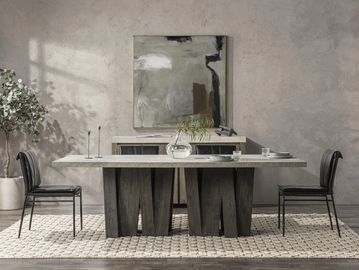 Modern dining room with stone table and black chairs.