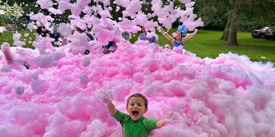 Children playing in hypoallergenic foam at a safe outdoor party