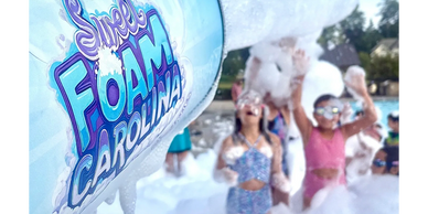Children playing in a safe, non-toxic foam party on a sunny summer afternoon
