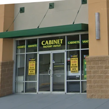 Storefront of Cabinet Factory Outlet offering granite countertops and kitchen cabinets.