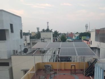 Solar panels installed on a residential rooftop in an urban area.