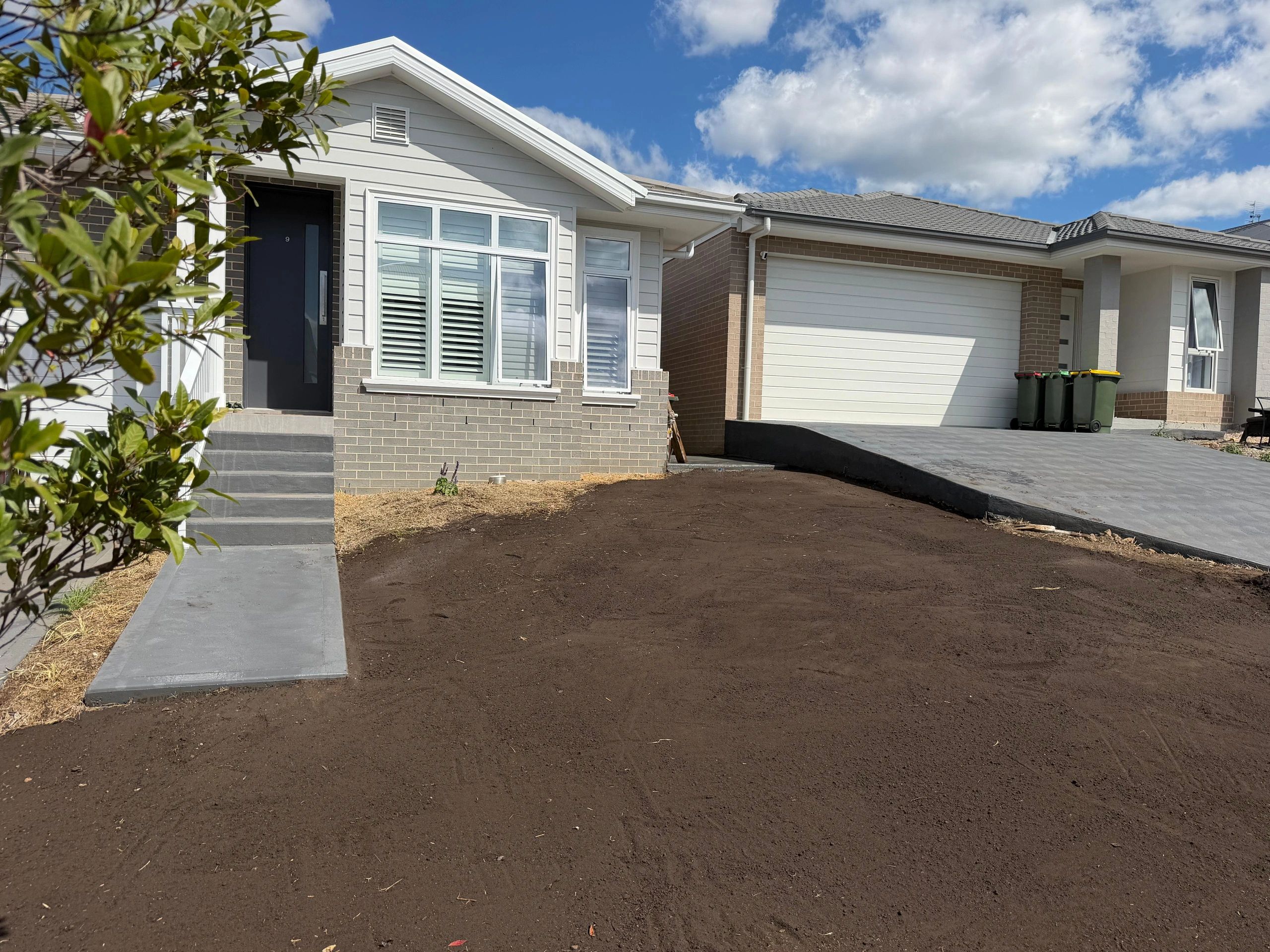New house with clean facade and empty front yard.