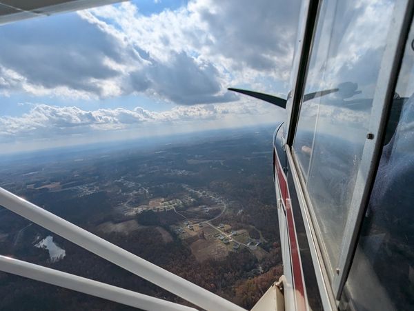 View from a small airplane over a rural landscape.