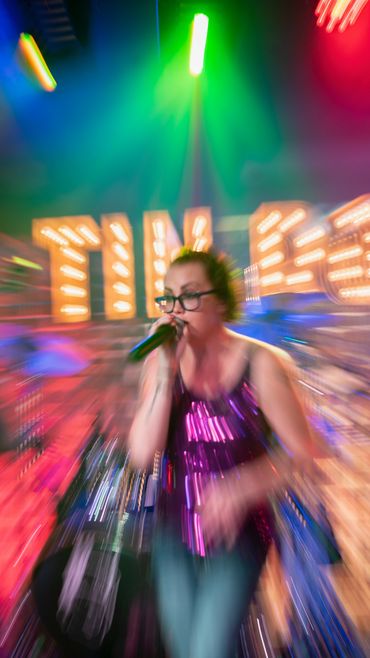 Niki shining brightly as she sings.