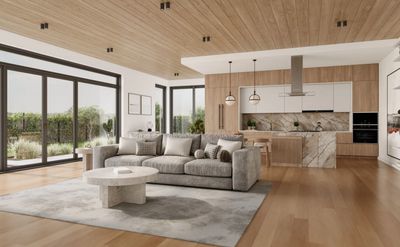 Modern open-plan living room and kitchen with natural wood accents and large windows.