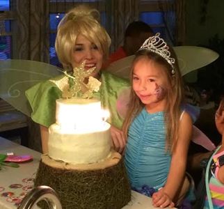 Houston princess tinkerbell princess party next to cake with birthday girl wearing a tiara