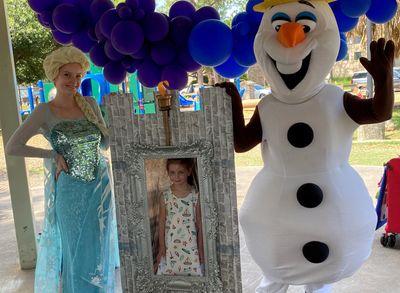 Ice Princess party characters  at a Meyerland birthday by the Photo prop with the moving flame torch