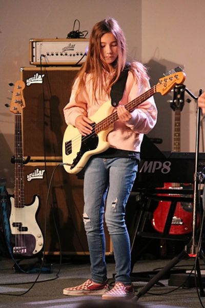 Young Female learning to play Bass at the Norman Music Institute