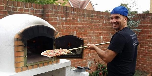 Pizza in a stone backed oven, the story of how woodz pizza started.