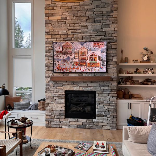 85-inch Samsung Frame TV mounted above stone fireplace in black Lake, WA