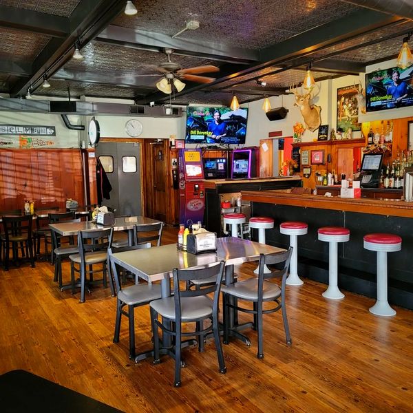 Inside Gunselman's Tavern restaurant and bar featuring original mahogany bar top and wooden floors 