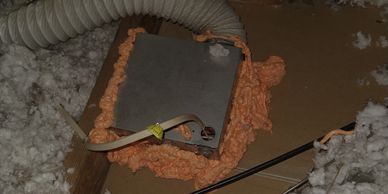 Attic with fire rated foam air sealing ventilation fan