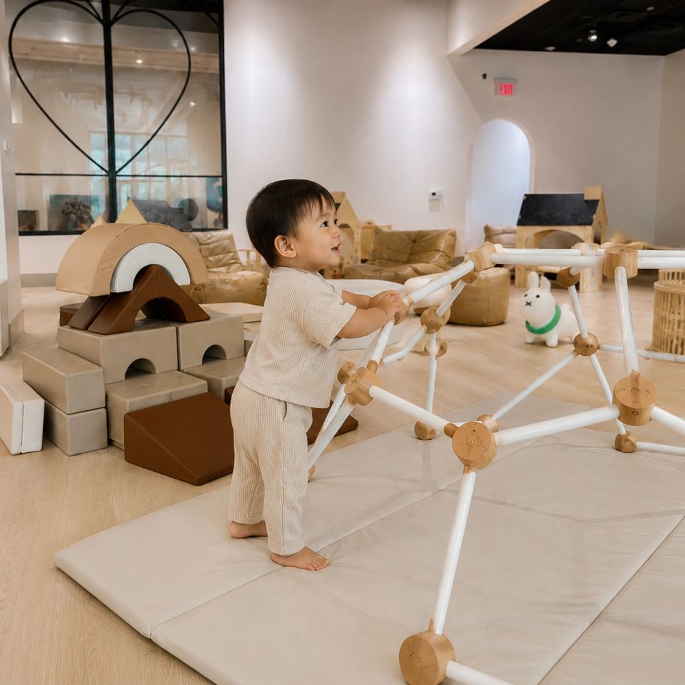 Toddler exploring a Montessori-inspired play structure at Wonder Play Cafe, a play cafe in Las Vegas