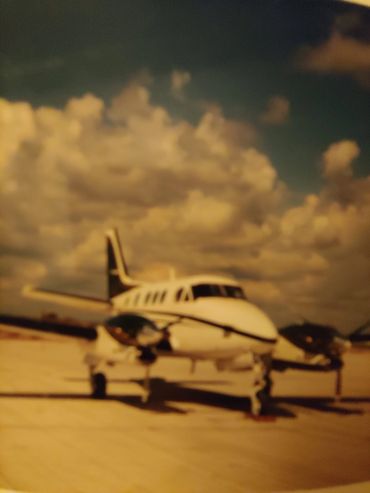 Vintage photo of a plane under cloudy sky