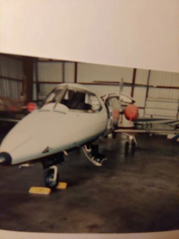 Nose view of a small jet in a hangar