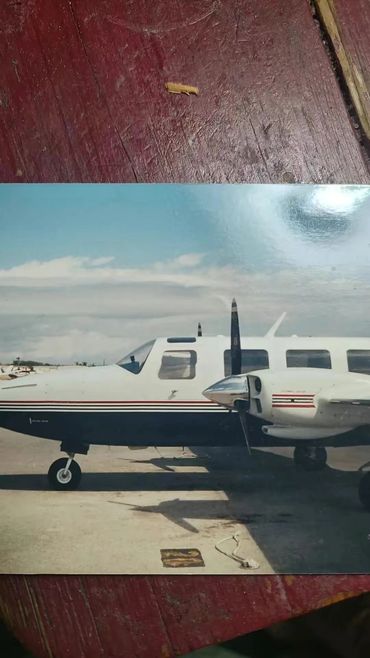 Small white propeller plane on runway