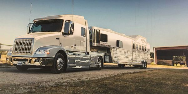 New heavy duty tow vehicle loading horses in a 48 foot custom trailer