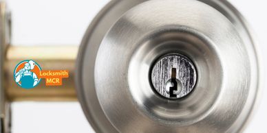 Close-up of various keys being cut on a professional key cutting machine by an expert locksmith.