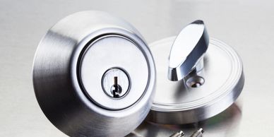 Locksmith installing a high-tech smart lock system on a sleek, contemporary office entrance.