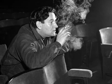 Wolf Mankowitz smoking in a cinema