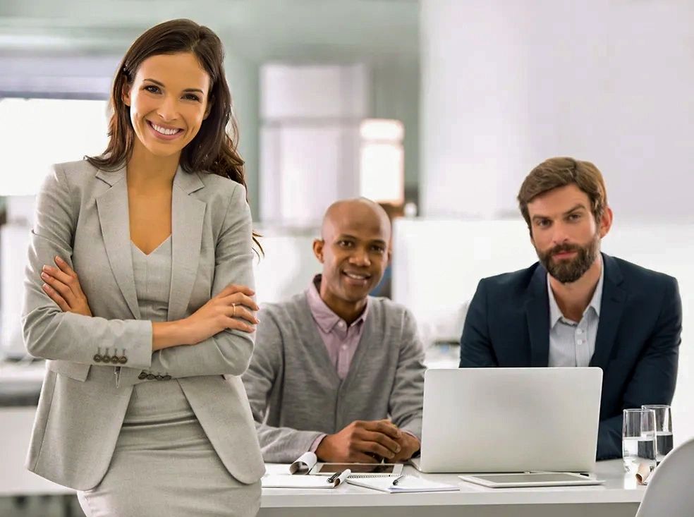 Beautiful young female commercial business owner stands confidently with her arms crossed.