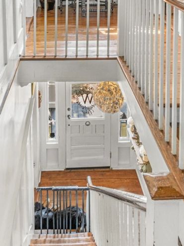 A view of a walkway, balcony, and stairs along with a white theme