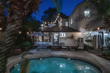 A view of a large property with a pool along with a beautiful theme and background