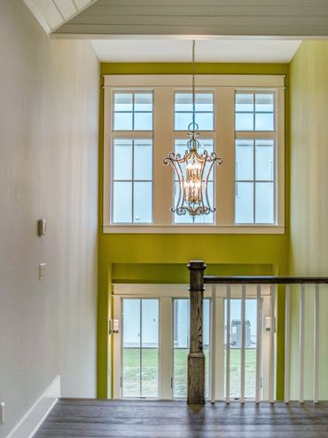 A view of a chandelier with a glass design and some yellow lights