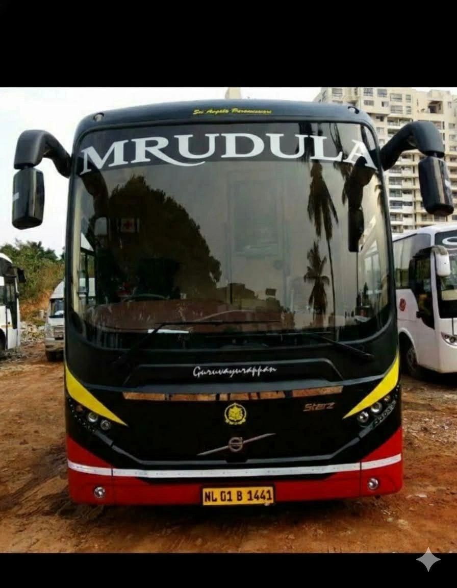 Front view of a bus named MRUDULA with a yellow and red design.