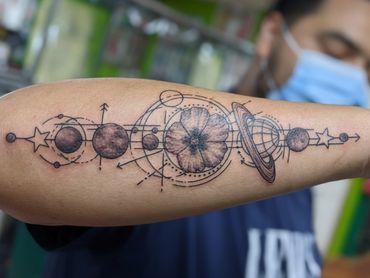 geometric floral flower tattoo forearm black and grey