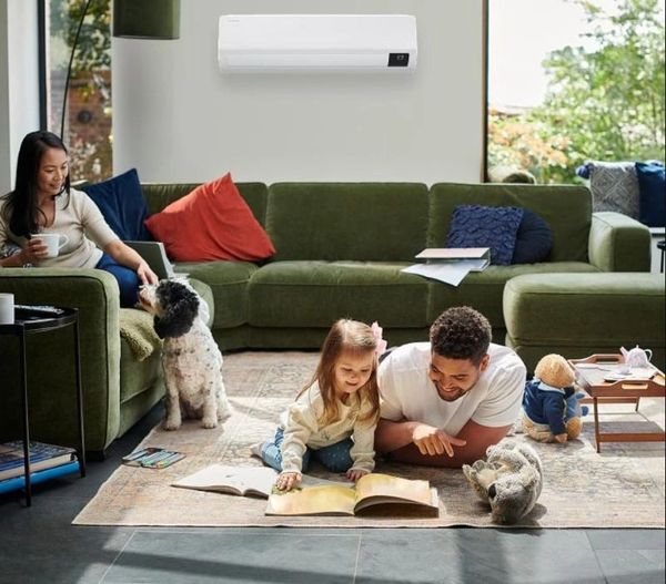 Family enjoying time together in a cozy living room with a dog and toys.