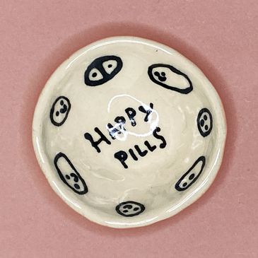 Small black and white ring dish wiht cute little smiling ovals and circles, and the words, "HAPPY PI