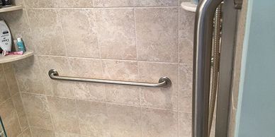 Multiple grab bars in a walk in shower