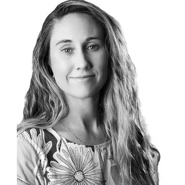 Black and white portrait of a woman with long hair and a floral top.