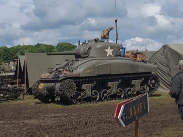 Lancaster flying over Sherman Tank