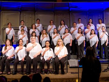 A choir group performing on stage.