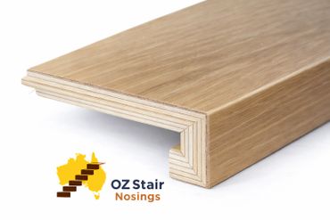 Close-up of a wooden stair nosing with layered plywood construction.