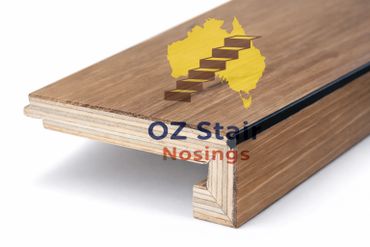 Close-up of wooden stair nosing with layered plywood construction.