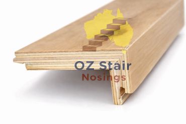 Close-up of wooden stair nosing profile showing layered plywood construction.