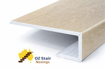 Wood-textured stair nosing profile for edge protection and aesthetics.