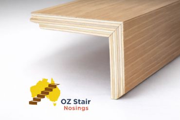 Close-up of a wooden stair nosing with layered plywood construction.
